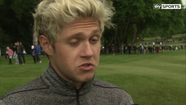 Niall Horan walks and talks with Wayne Riley during the BMW PGA pro